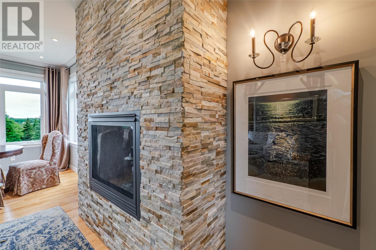 Stone feature wall with a propane fireplace - 131-139 Marine Drive, Logy Bay, Middle Cove, Outer Cove, NL - Indoor With Fireplace