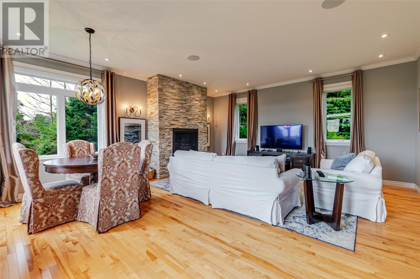 The family room is great for playing games or eating your morning breakfast at the table. - 131-139 Marine Drive, Logy Bay, Middle Cove, Outer Cove, NL - Indoor With Fireplace
