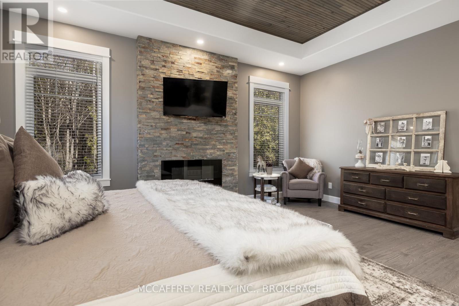 219 Kidds Road, Stone Mills (Stone Mills), ON - Indoor Photo Showing Bedroom With Fireplace