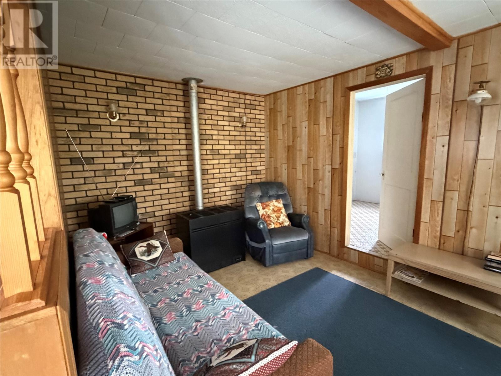 1202 Western Bay Line, Western Bay, NL - Indoor Photo Showing Other Room With Fireplace
