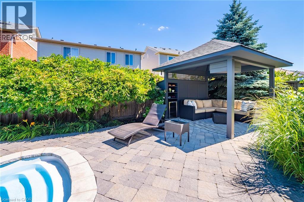 Expansive backyard oasis featuring a covered pergola structure with integrated seating area, permeable paver patio, mature landscaping with lush hedges and specimen trees, and lounge seating - 1533 Morse Place, Milton, ON - Outdoor With In Ground Pool With Deck Patio Veranda