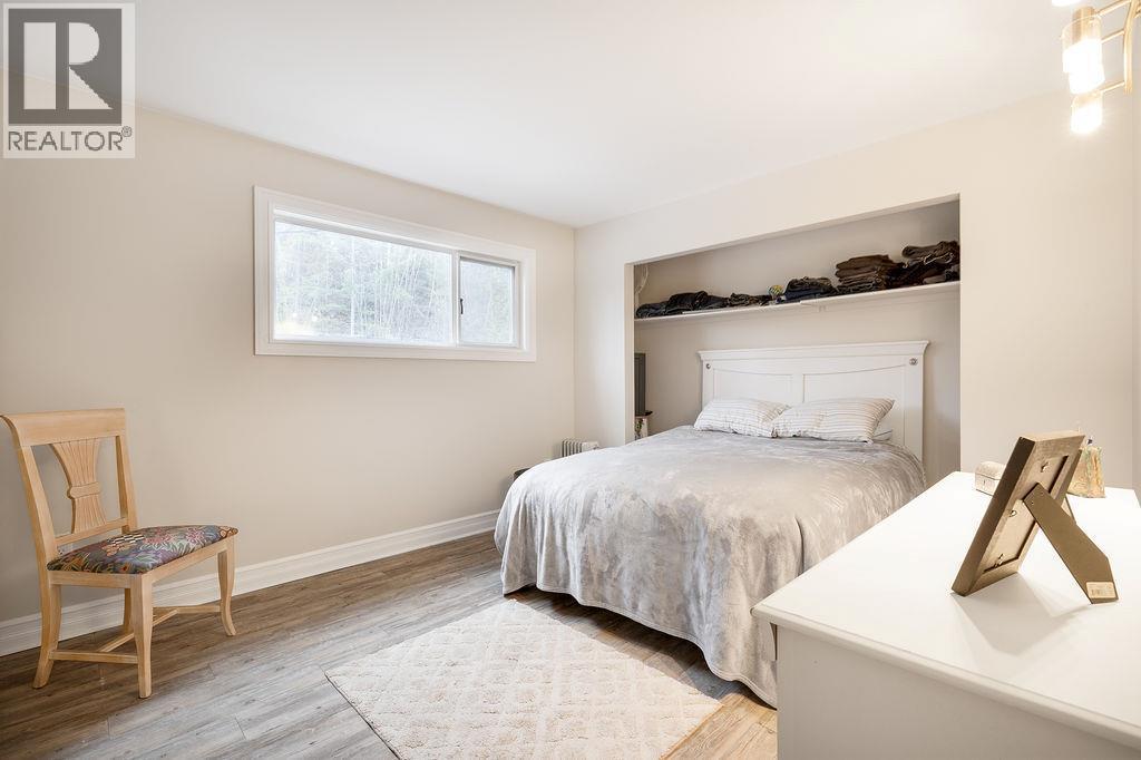 Second bedroom on main floor. Window facing from yard. - 2527 Islandview Road, Blind Bay, BC - Indoor Photo Showing Bedroom