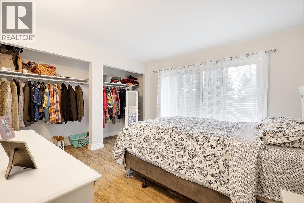 Primary bedroom with lots of closet space. - 2527 Islandview Road, Blind Bay, BC - Indoor Photo Showing Bedroom