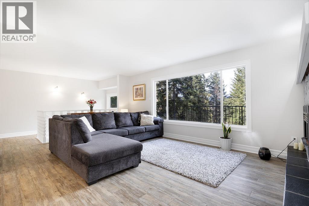 Living room. Stairs to the basement are behind the couch area. Very open and airy space. - 2527 Islandview Road, Blind Bay, BC - Indoor Photo Showing Living Room