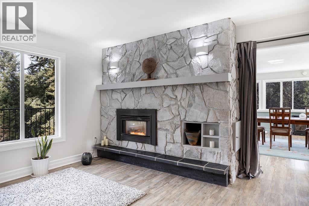 Fire place in the living room - 2527 Islandview Road, Blind Bay, BC - Indoor Photo Showing Living Room With Fireplace