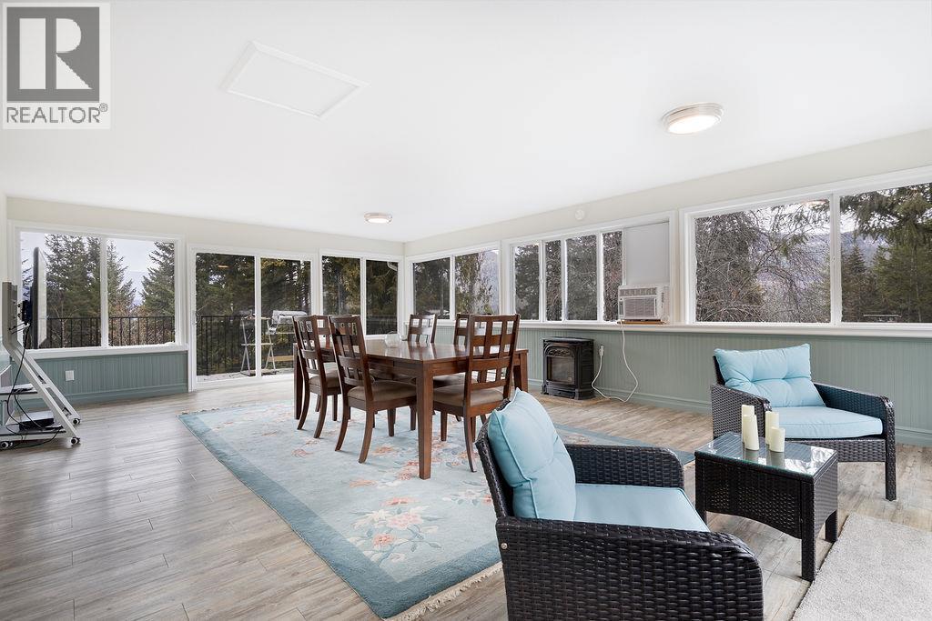 Sunroom. Large windows surround the sunroom for lots of light throughout the day. - 2527 Islandview Road, Blind Bay, BC - Indoor