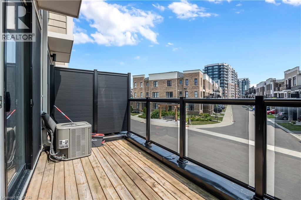 Balcony with wood-finish flooring and glass panel railing - 1451 Green Road, Bowmanville, ON - Outdoor With Exterior