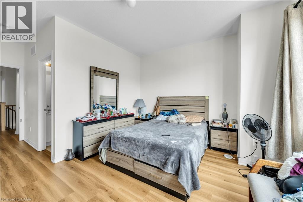 Bedroom featuring light wood-finish flooring, neutral wall tones, and a window with floor-length drapes - 1451 Green Road, Bowmanville, ON - Indoor Photo Showing Bedroom
