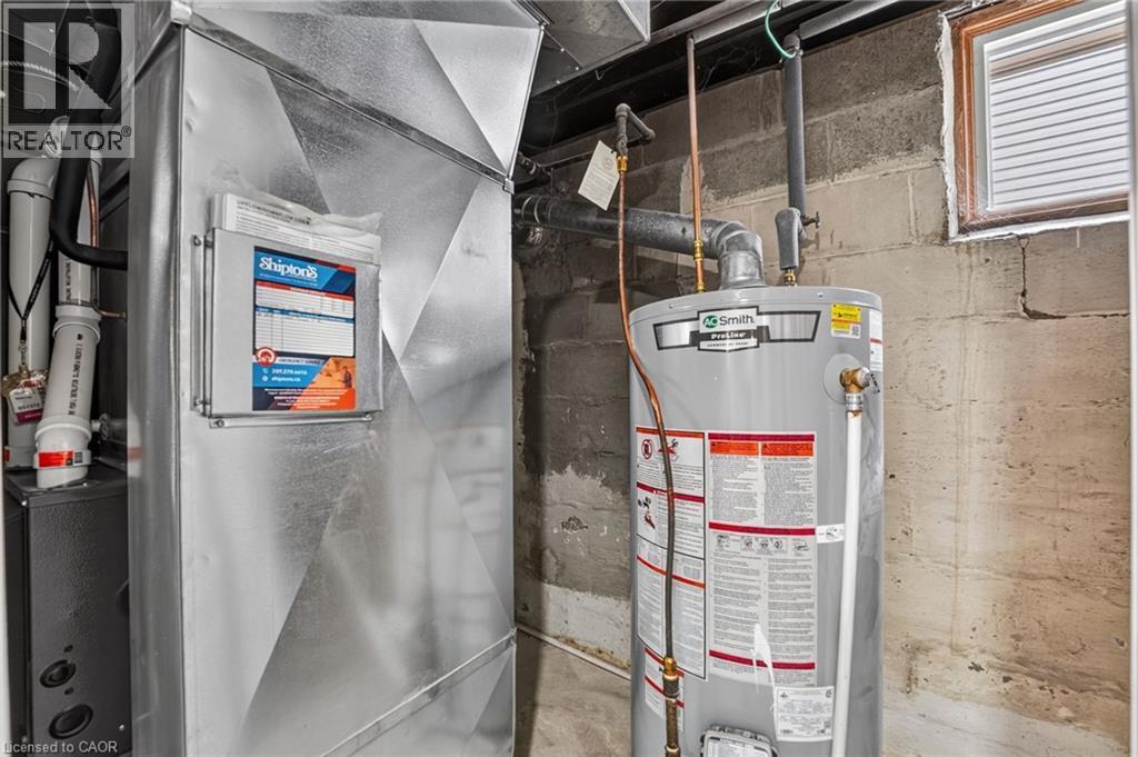 Galvanized ductwork with a water heater and concrete block walls - 36 Mahony Avenue, Hamilton, ON - Indoor Photo Showing Basement