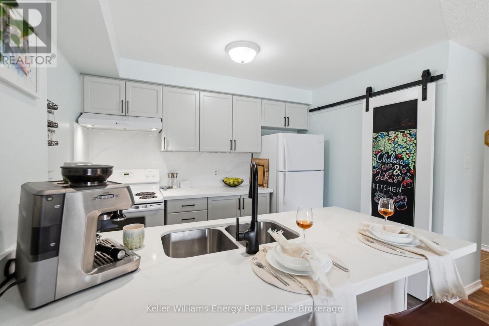 Recently painted Cupboards - 204 - 124 Aspen Springs Drive, Clarington (Bowmanville), ON - Indoor Photo Showing Kitchen With Double Sink