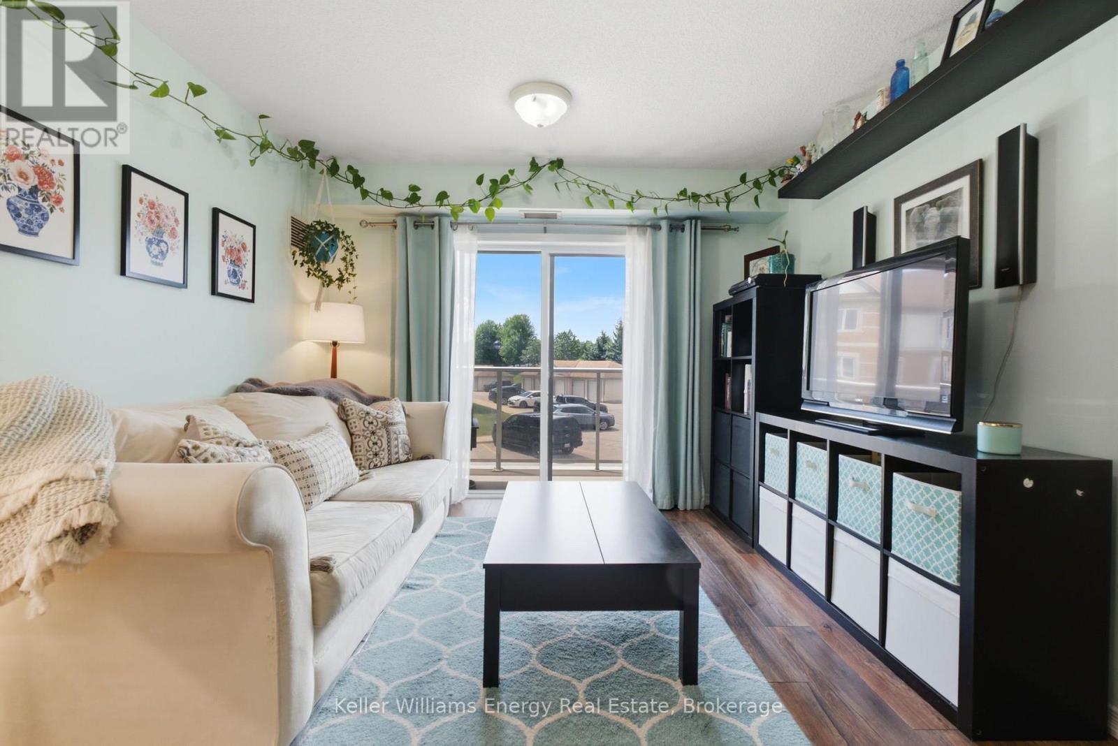 Walk out to full Balcony - 204 - 124 Aspen Springs Drive, Clarington (Bowmanville), ON - Indoor Photo Showing Living Room