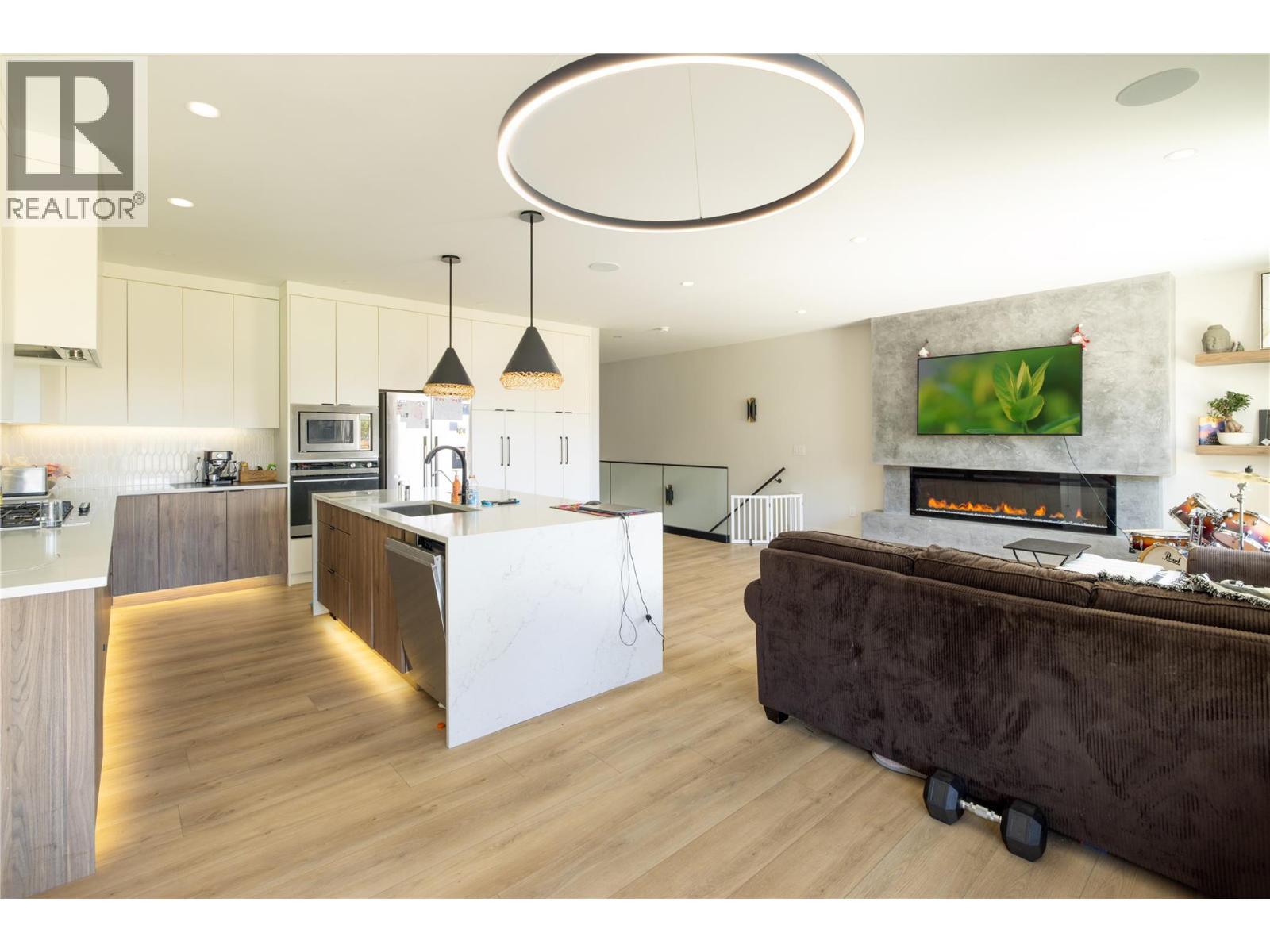 10272 Long Road, Lake Country, BC - Indoor Photo Showing Kitchen With Fireplace With Double Sink