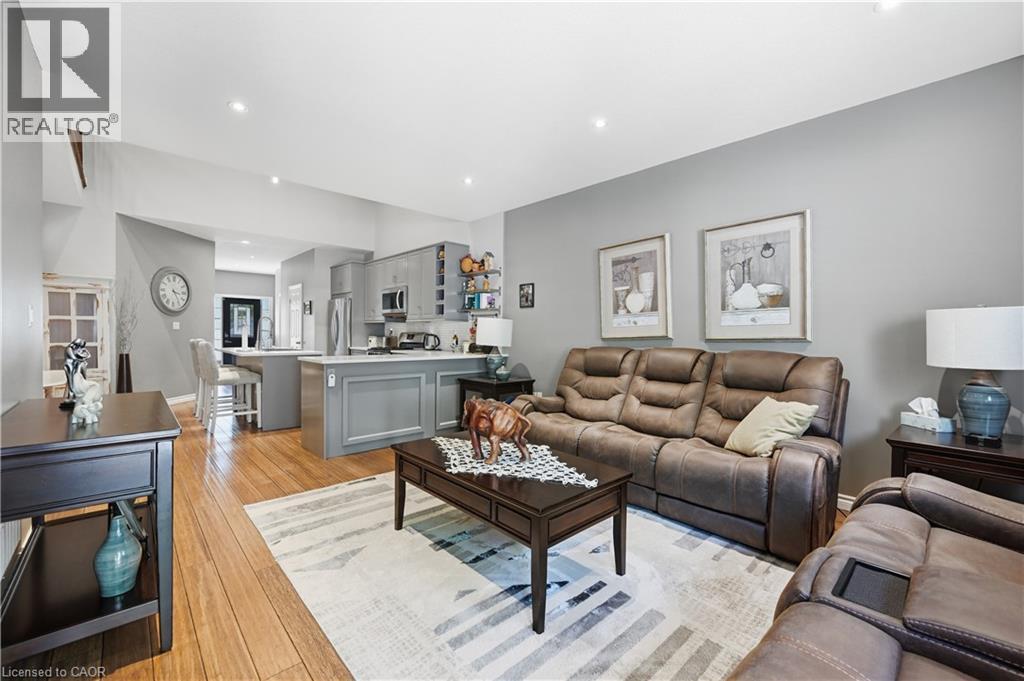 Open-concept living area featuring wood-finish flooring, recessed lighting, and a neutral wall palette - 10 Kopperfield Lane, Hamilton, ON - Indoor Photo Showing Living Room