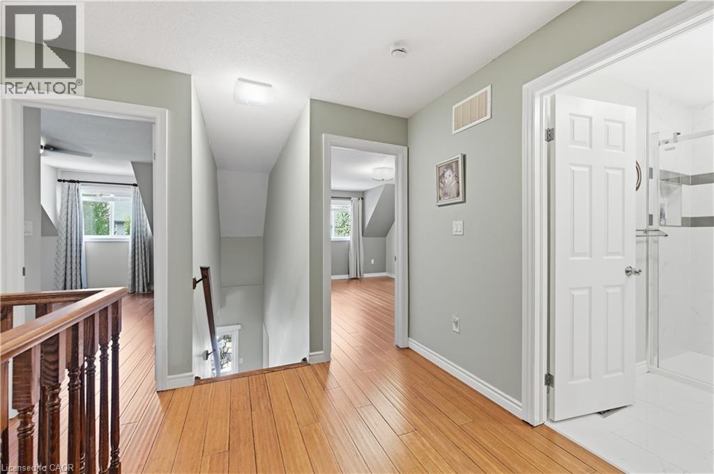 Upper-level hallway featuring wood-finish flooring, light gray wall paint, and white trim - 10 Kopperfield Lane, Hamilton, ON - Indoor Photo Showing Other Room