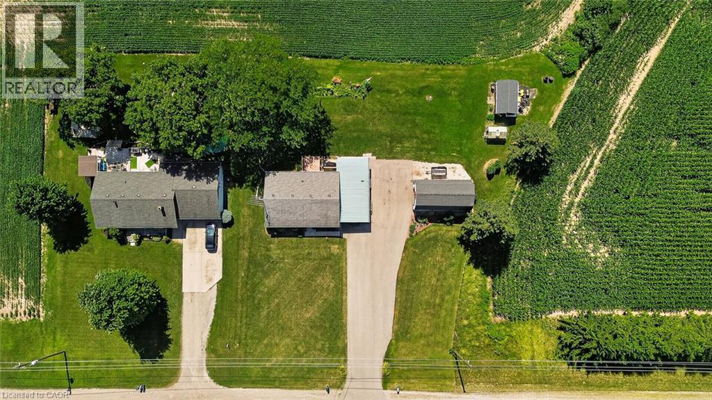 Aerial perspective showcasing a residential property with surrounding agricultural fields - 184726 Cornell Road, Tillsonburg, ON - Outdoor With View