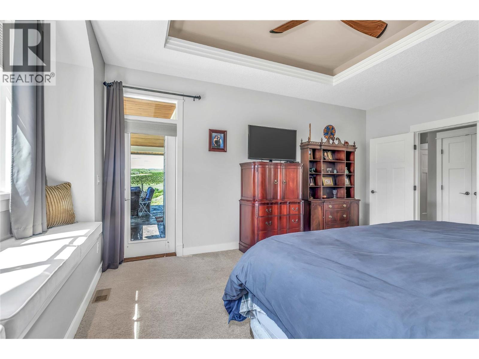Access to Balcony - 8780 Braeburn Drive, Coldstream, BC - Indoor Photo Showing Bedroom