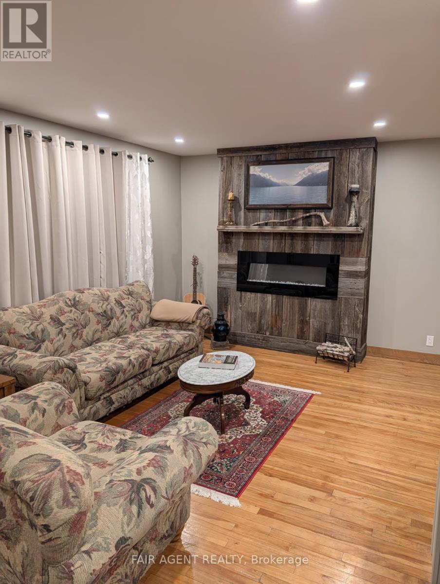 Primary Residence - 743022 & 743024 Dawson Point Road, Timiskaming (Tim - Outside - Rural), ON - Indoor Photo Showing Living Room With Fireplace