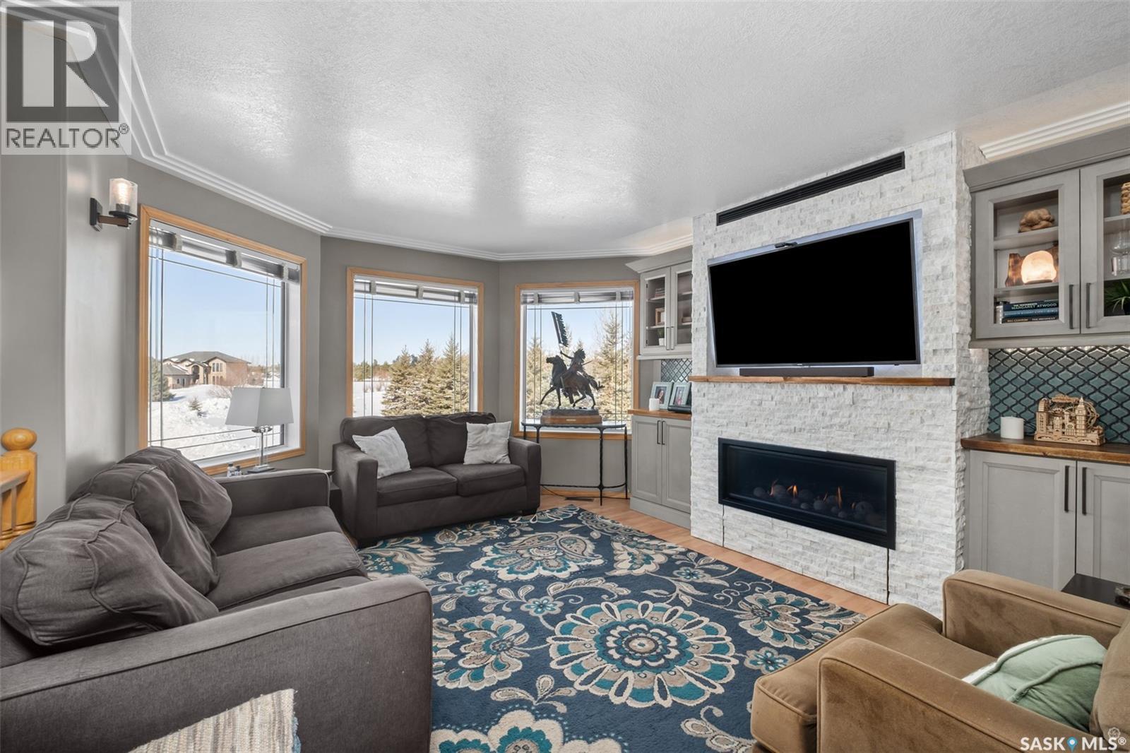 808 Lakeridge Drive, Buckland Rm No. 491, SK - Indoor Photo Showing Living Room With Fireplace