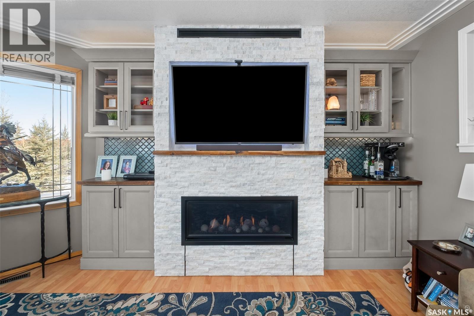 808 Lakeridge Drive, Buckland Rm No. 491, SK - Indoor Photo Showing Living Room With Fireplace