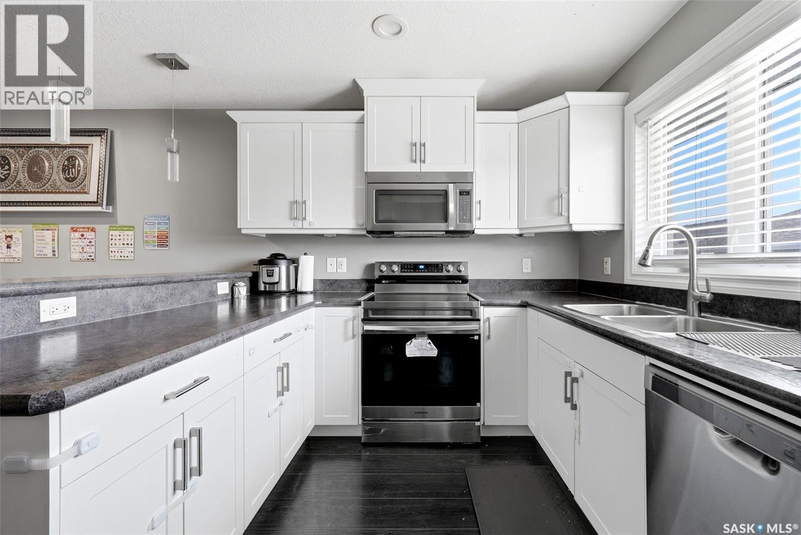 5669 Cederholm Avenue, Regina, SK - Indoor Photo Showing Kitchen With Stainless Steel Kitchen With Double Sink