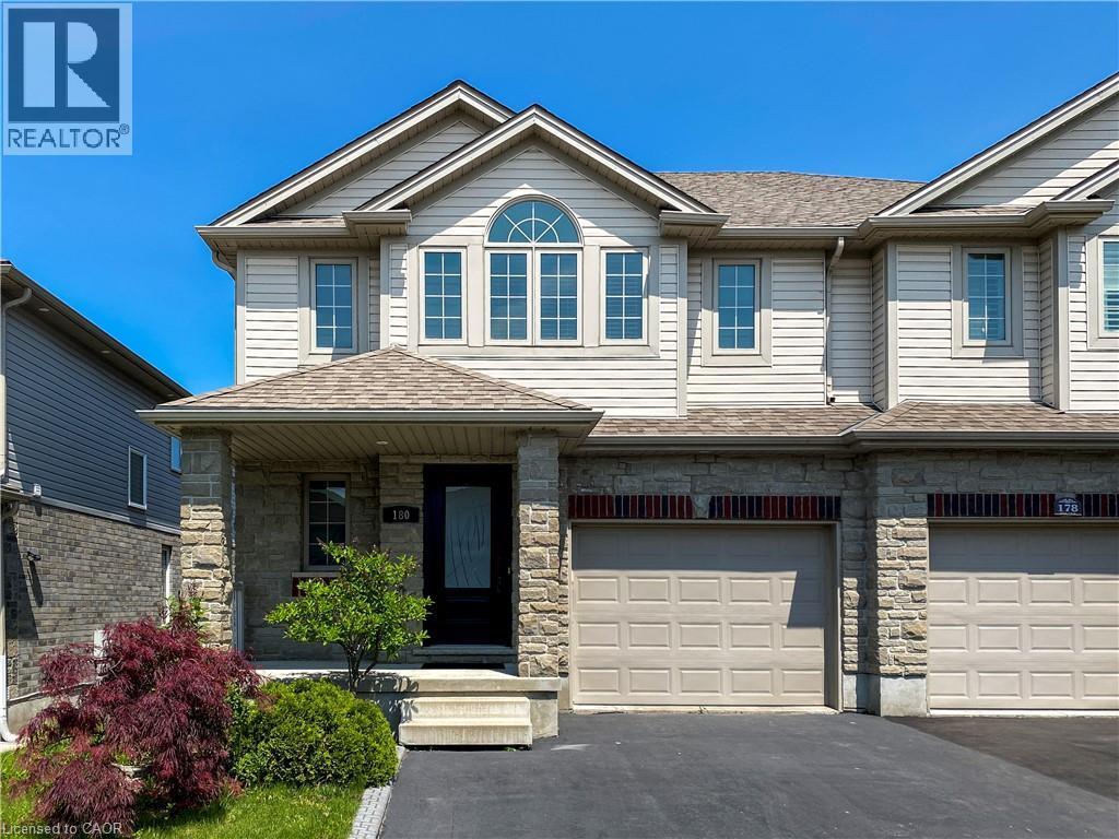 Two-story townhome featuring a stone and siding facade - 180 Huck Crescent, Kitchener, ON - Outdoor With Facade