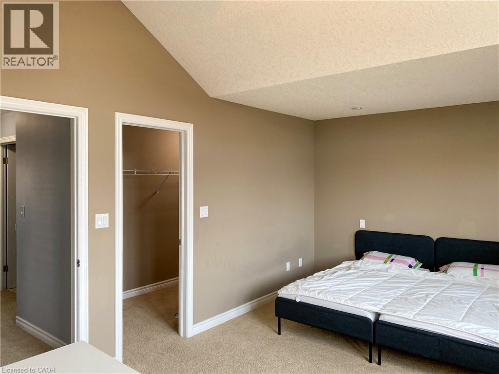 Room featuring neutral tone walls, white trim, and beige carpet flooring - 180 Huck Crescent, Kitchener, ON - Indoor Photo Showing Bedroom