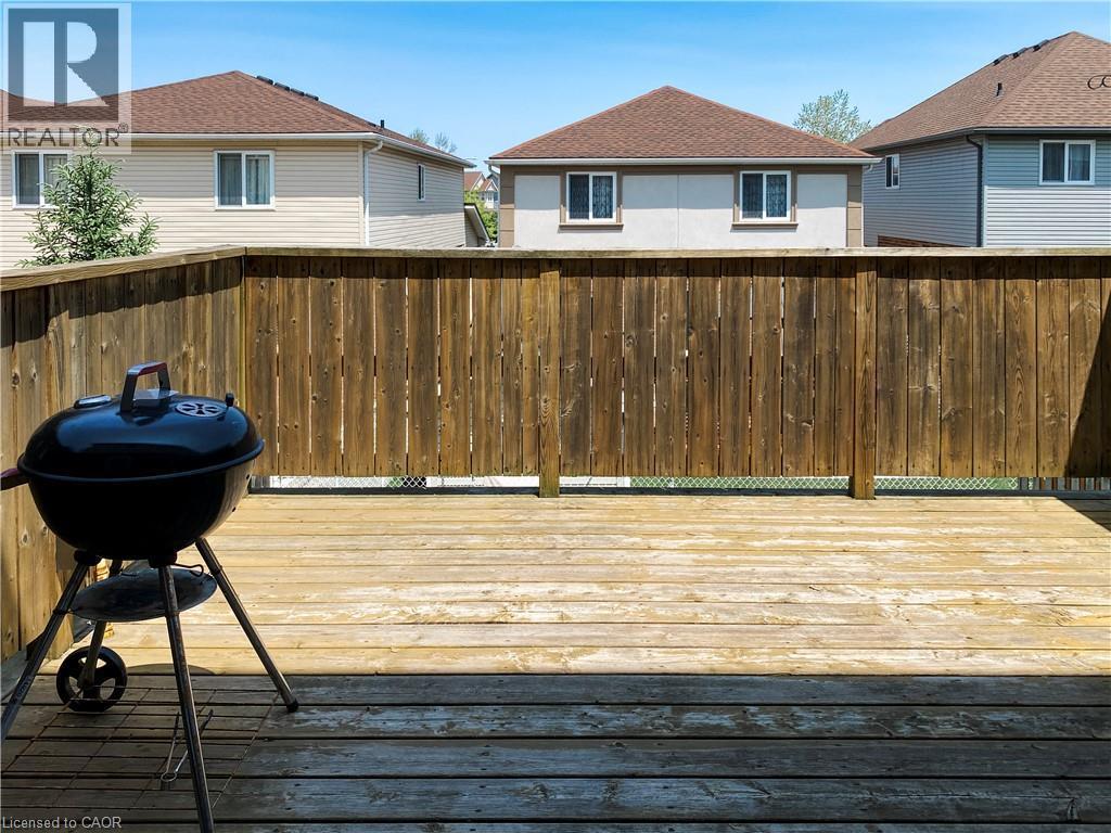 Outdoor wood-finish deck with a high wood privacy fence - 180 Huck Crescent, Kitchener, ON - Outdoor With Deck Patio Veranda With Exterior