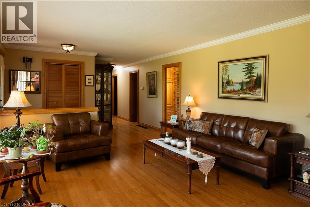 Spacious living area featuring wood-finish flooring, light-colored walls, and detailed crown molding - 269 Brant County Road 22, Ancaster, ON - Indoor Photo Showing Living Room