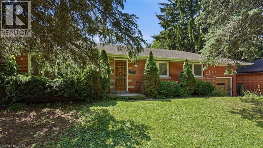 Brick exterior with a prominent wooden entry door - 524 Dorval Drive, Ancaster, ON - Outdoor
