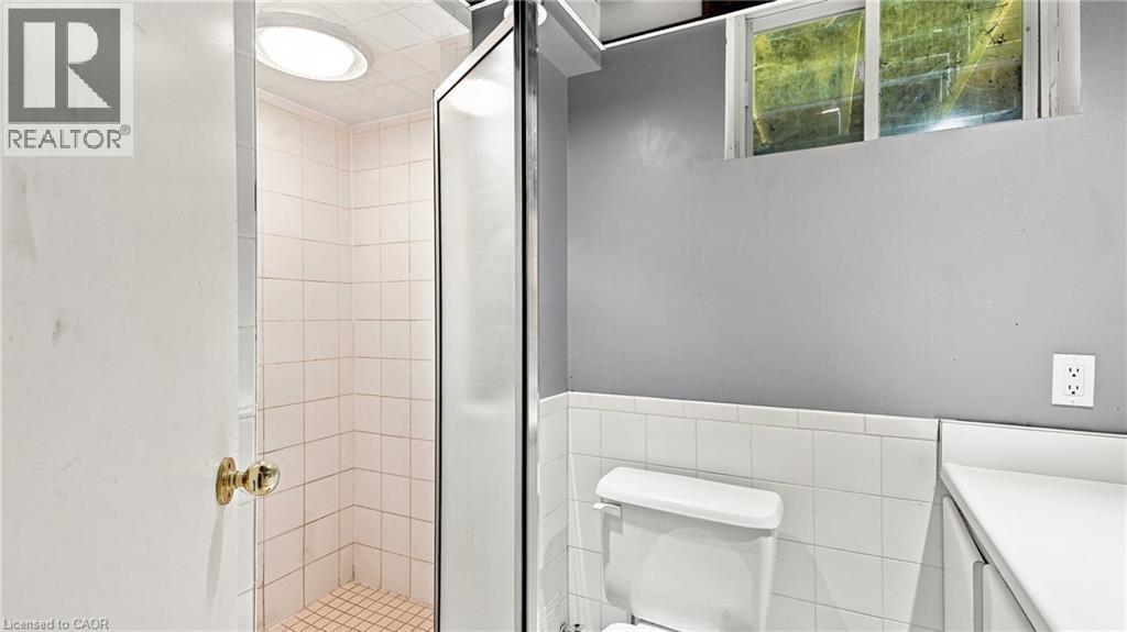 Shower stall with tiled walls and floor, enclosed by a glass and metal frame - 524 Dorval Drive, Ancaster, ON - Indoor Photo Showing Bathroom