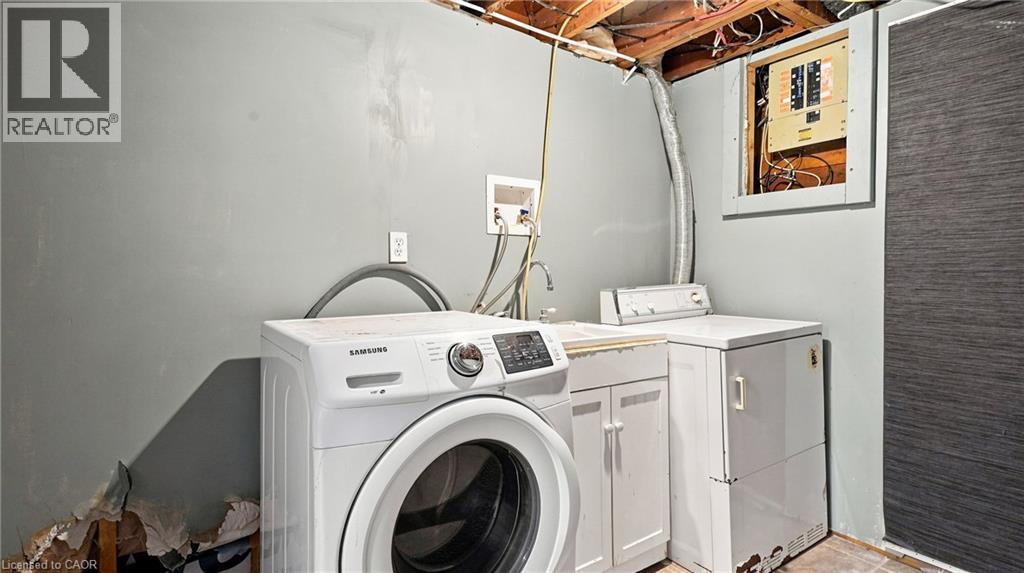 Dedicated laundry area featuring a utility sink and exposed ceiling joists - 524 Dorval Drive, Ancaster, ON - Indoor Photo Showing Laundry Room