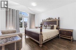 Vaulted ceilings and wood-finish flooring highlight this bedroom space - 