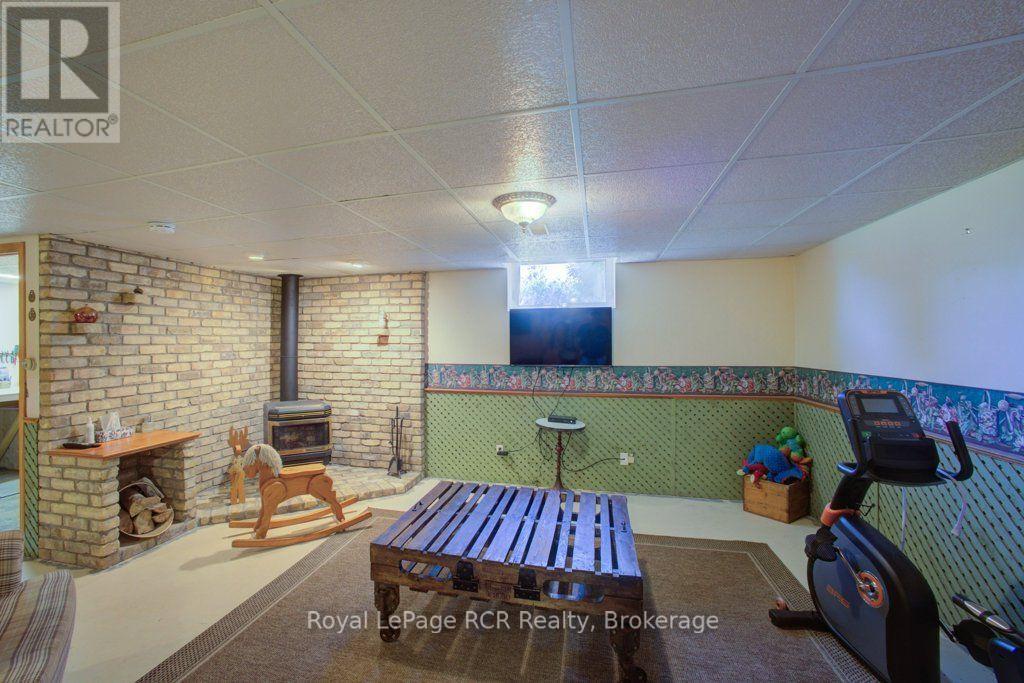 Rec room with pellet stove - 7195 Sixteenth Line, Mapleton, ON