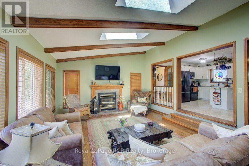 Sunken living room with wood stove - 7195 Sixteenth Line, Mapleton, ON