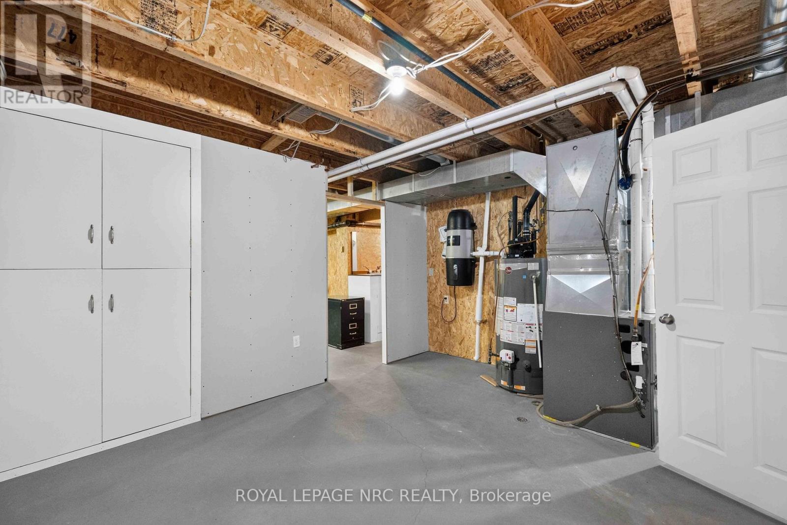Utility Room with Owned Hot Water Tank - 82 Maple Street, Port Colborne (Sugarloaf), ON - Indoor Photo Showing Basement