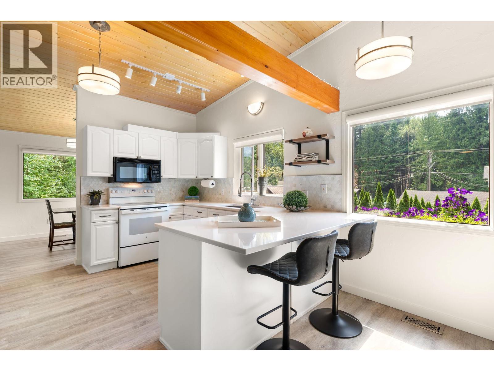New kitchen main level with eating island/bar - 1587 Pratico Road, Revelstoke, BC - Indoor Photo Showing Kitchen