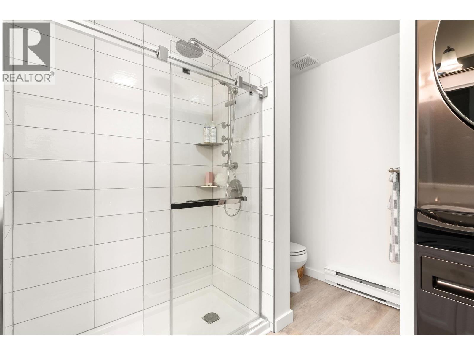 Laundry in main floor bathroom - 1587 Pratico Road, Revelstoke, BC - Indoor Photo Showing Bathroom