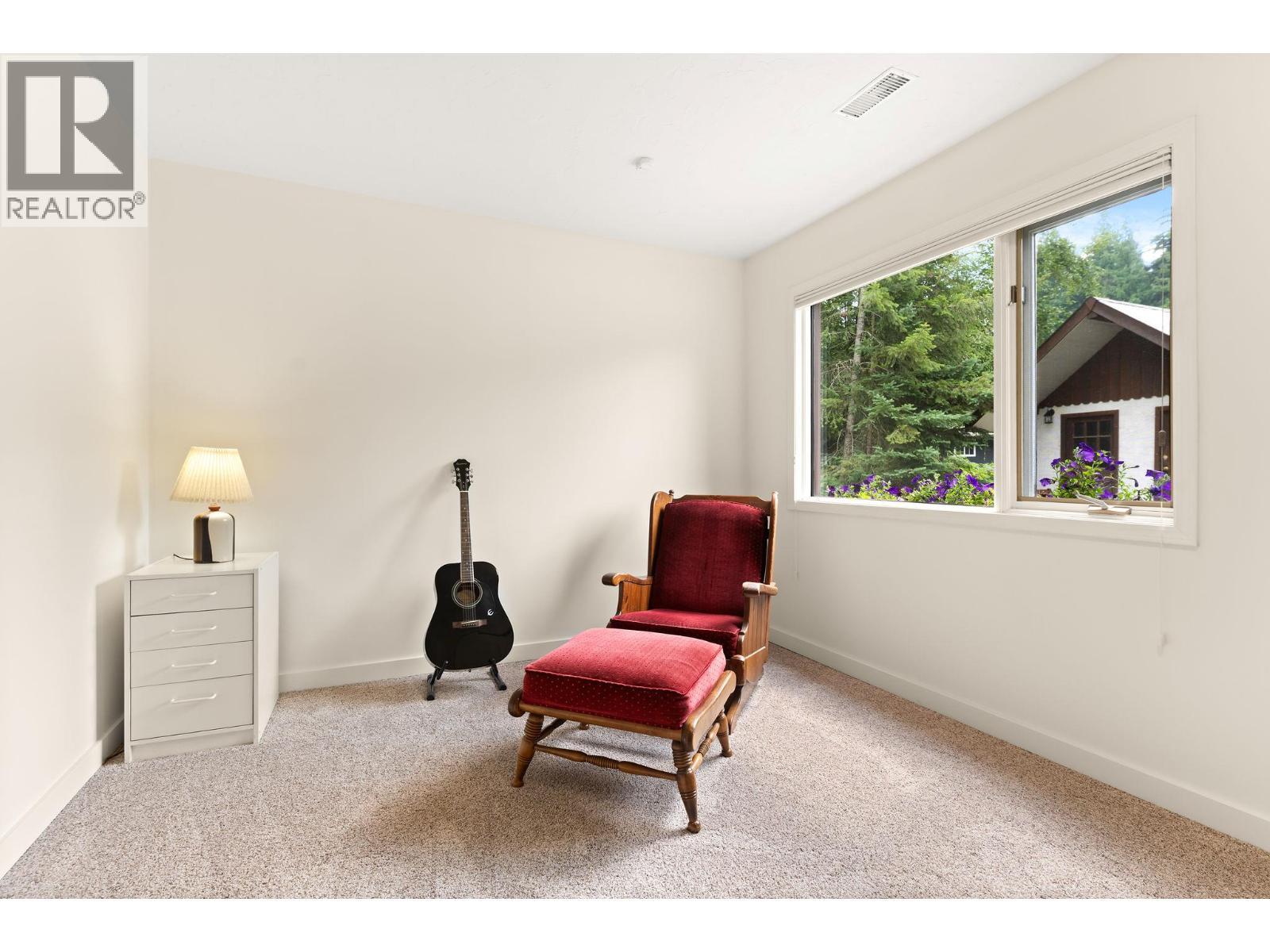 Bedroom 2 lower level, large windows - 1587 Pratico Road, Revelstoke, BC - Indoor