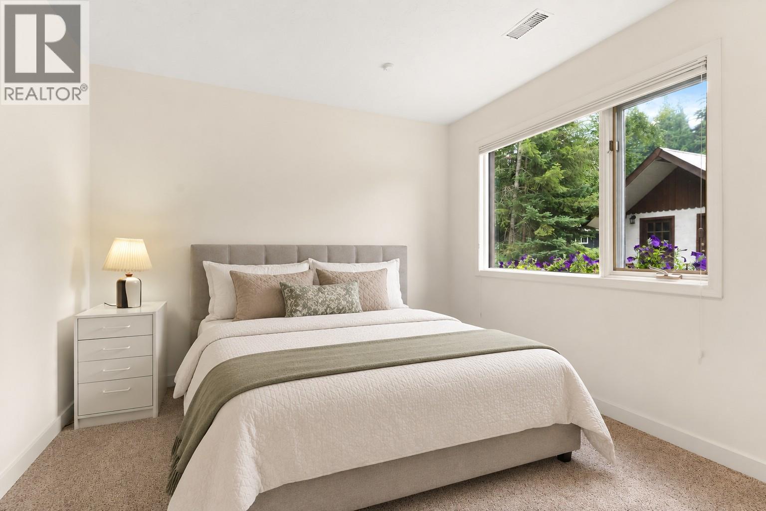 Bedroom 2 lower level this picture digitally staged - 1587 Pratico Road, Revelstoke, BC - Indoor Photo Showing Bedroom