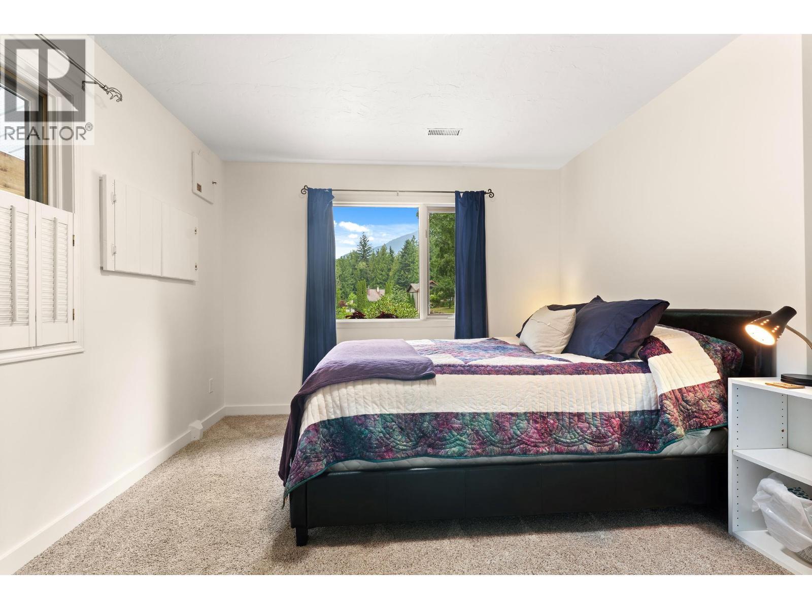 Large primary Bedroom 1 lower level - 1587 Pratico Road, Revelstoke, BC - Indoor Photo Showing Bedroom