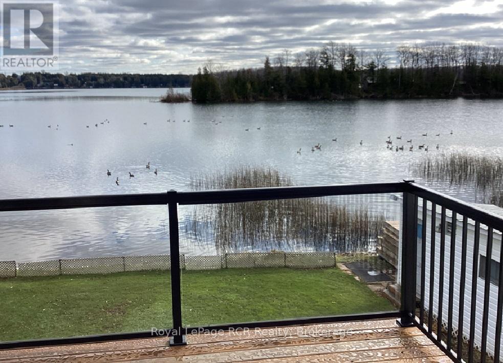CLEAR GLASS RAILING ON NEWER DECK - 48 Island View Drive N, South Bruce Peninsula, ON - Outdoor With Body Of Water With View
