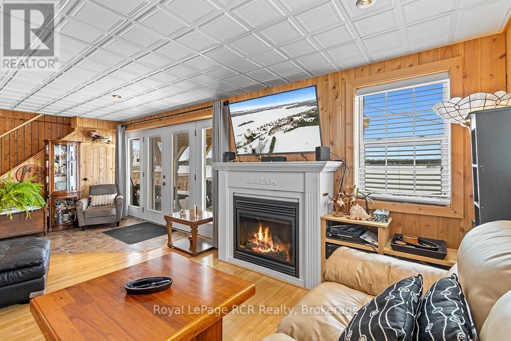 LOWER LEVEL WITH WALK OUT TO THE LAKE - 48 Island View Drive N, South Bruce Peninsula, ON - Indoor Photo Showing Living Room With Fireplace