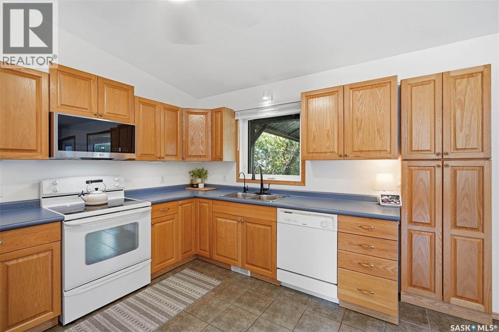 24 Airport Drive, Candle Lake, SK - Indoor Photo Showing Kitchen With Double Sink