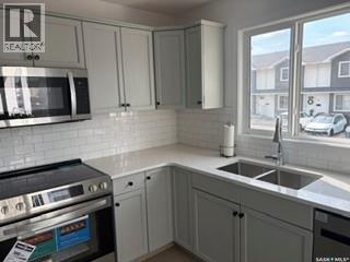 35 4850 Harbour Landing Drive, Regina, SK - Indoor Photo Showing Kitchen With Double Sink