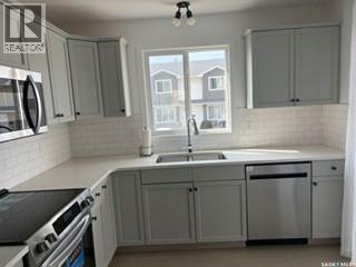 35 4850 Harbour Landing Drive, Regina, SK - Indoor Photo Showing Kitchen With Double Sink