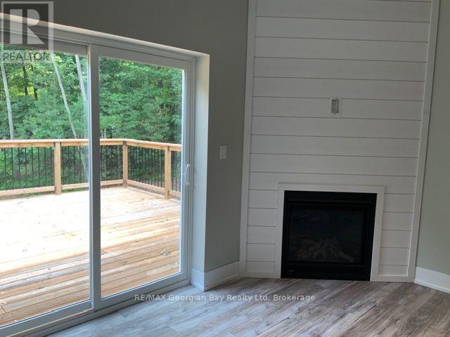5 Oakwood Avenue S, Tiny, ON - Indoor Photo Showing Other Room With Fireplace