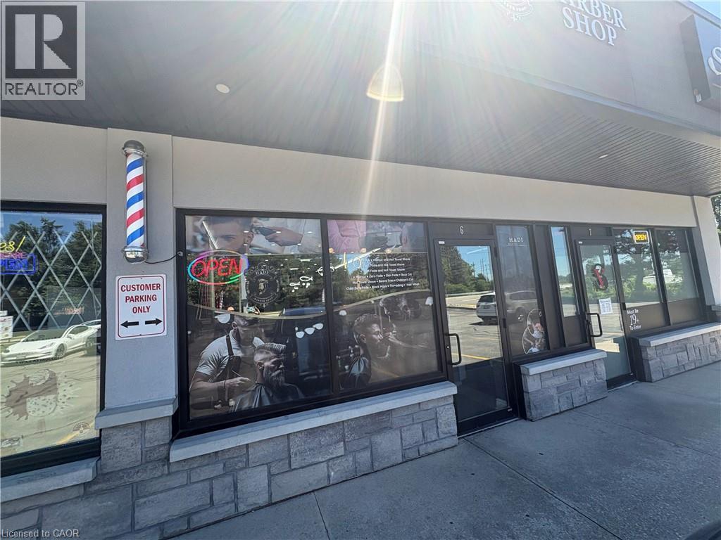 Commercial storefront with multiple glass entry doors and large display windows - 209 Lexington Road Unit# F, Waterloo, ON