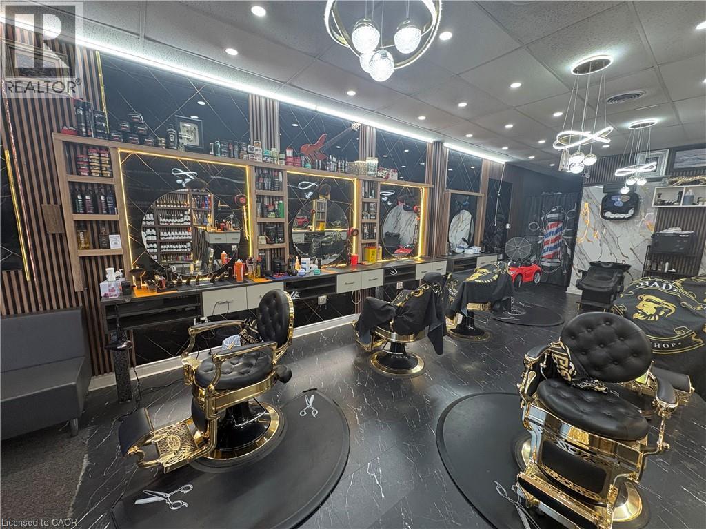 Commercial interior with sleek dark flooring and multiple service stations - 209 Lexington Road Unit# F, Waterloo, ON