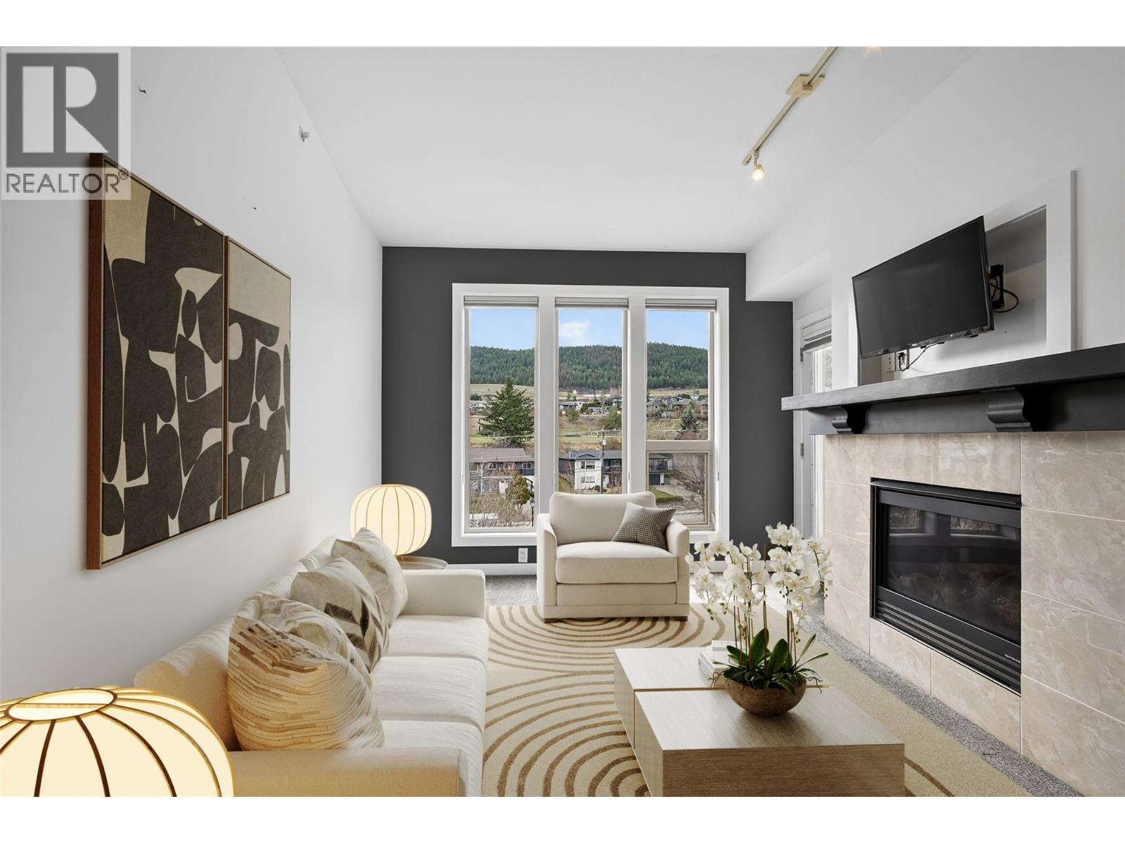 Virtually Staged, Modern Living Space With Cozy Gas Fireplace - 7343 Okanagan Landing Road Unit# 2402, Vernon, BC - Indoor Photo Showing Living Room With Fireplace