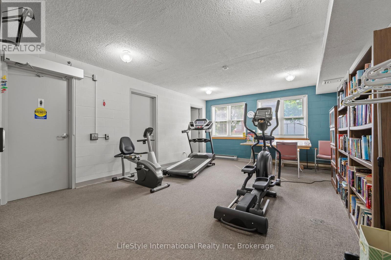 Free 24/7 use - Exercise Equipment, Library, Games - 306 - 208 Silvercreek Parkway N, Guelph (Junction/Onward Willow), ON - Indoor Photo Showing Gym Room